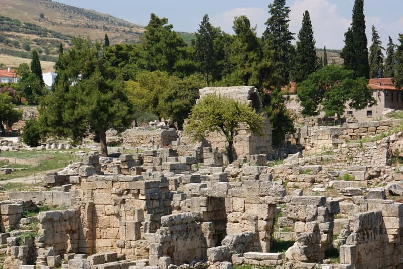 Athens: Ancient Corinth Tour with Official Guide & Tickets - Entering Ancient Corinth beside Apollo’s Temple