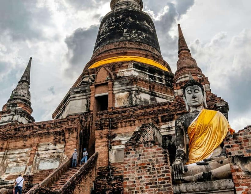 From Bangkok: Ayutthaya Heritage Tour with Sunset Boat Ride - Wat Maha That and the Buddha in the roots